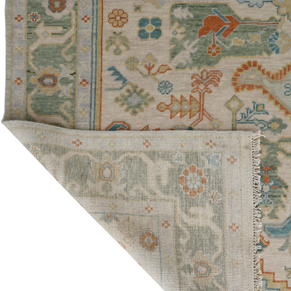 Close-up of a patterned rug with intricate designs on a white background