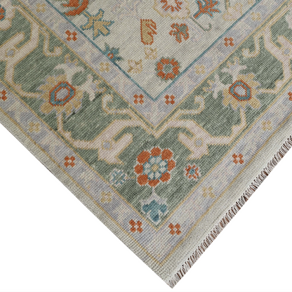 Corner of a patterned rug with geometric design on a white background