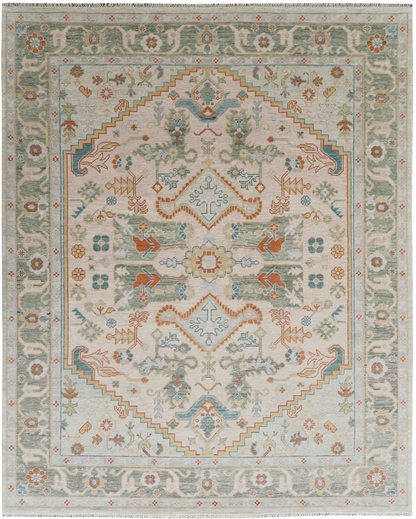 Close-up view of a handmade rug with floral and geometric patterns in beige, blue, green, and orange colors