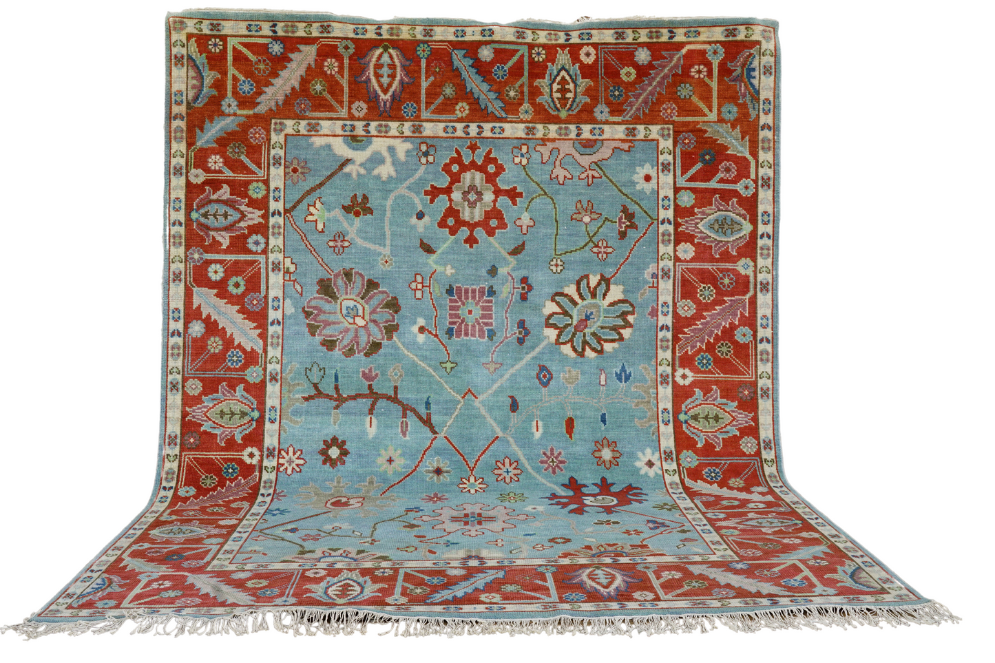 heidi handmade wool rug close-up showing rich rust and turquoise fibers and premium handwoven texture