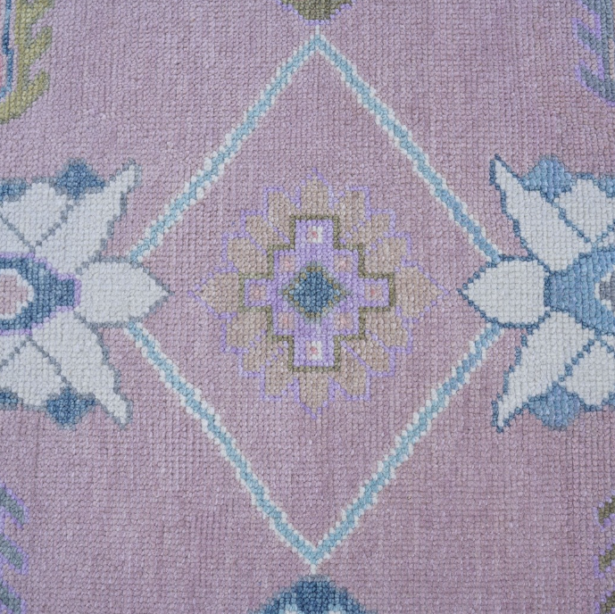 Close-up of a patterned fabric with geometric shapes on a purple background