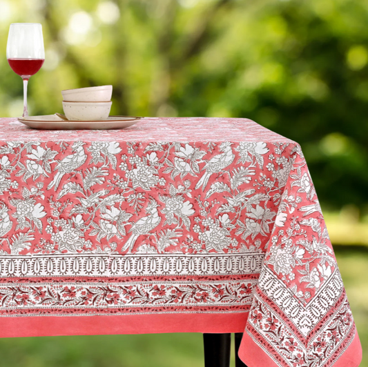 Tablecloth with floral and bird pattern on a table outdoors