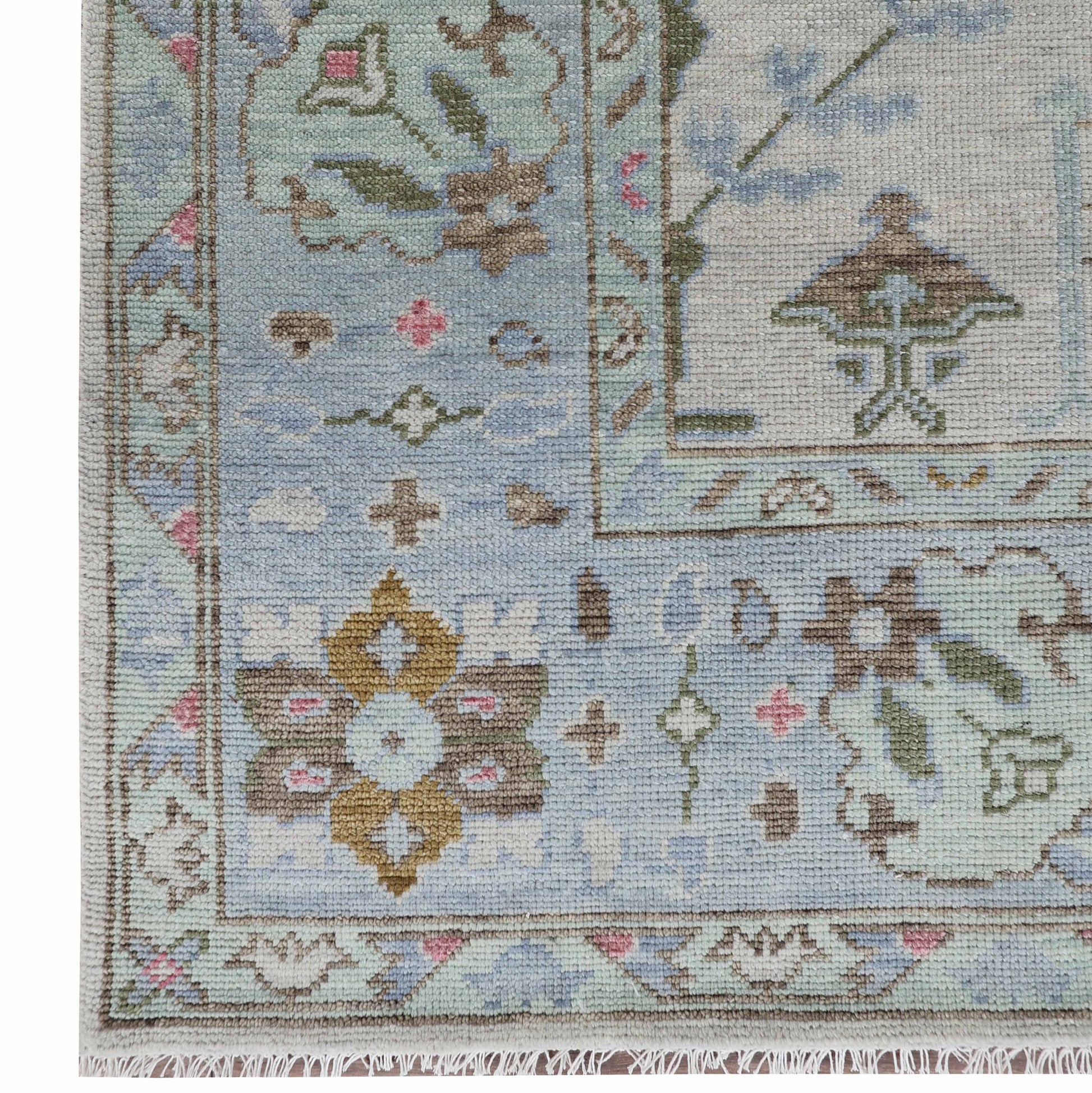 Close-up of the Amelia rug’s blue, ivory, pink and green pattern