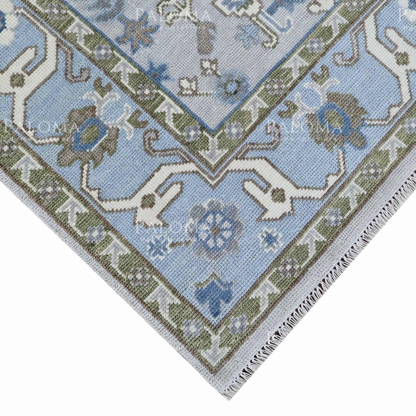 Bennett Oushak rug with soft blue border and green detailing
