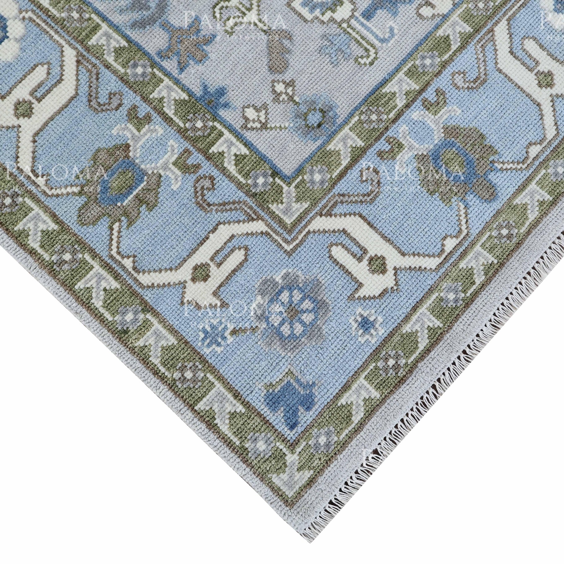 Bennett Oushak rug with soft blue border and green detailing